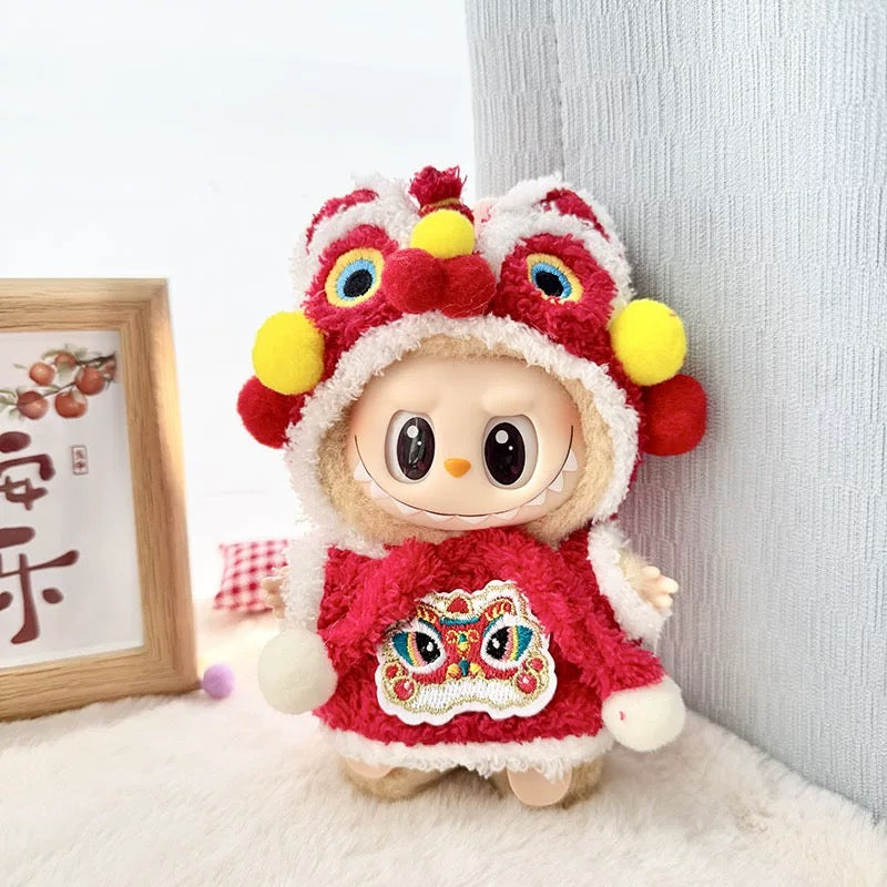 Toy dressed in a red outfit with a lion head design on a light background