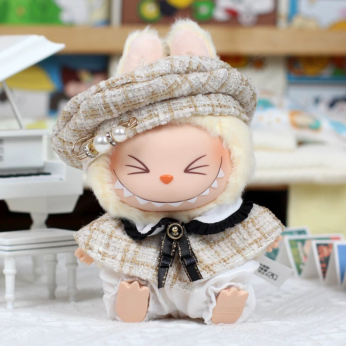Plush toy with a checkered hat and outfit in a blurred indoor setting