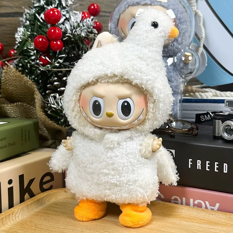 Plush toy resembling a character with a white fluffy outfit and orange feet on a wooden surface.