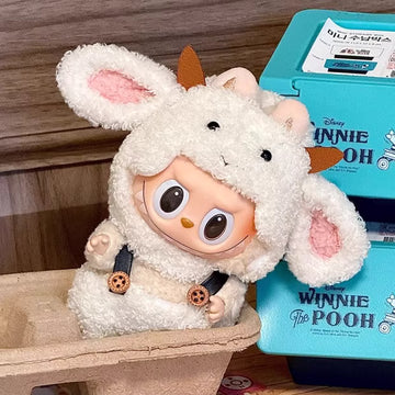 labubu figure in a sheep costume with a Winnie the Pooh book in the background